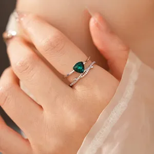 Elegant double-layered silver ring featuring a triangular green gemstone and zircon pavé