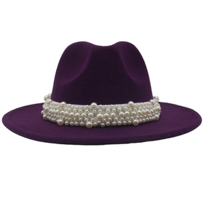 Detail of elegant dark purple wool fedora hat featuring a white faux pearl embellished band