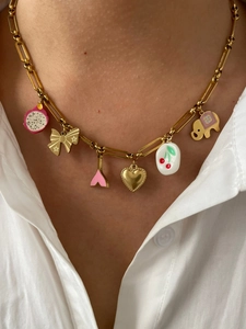 Detailed close-up of a paperclip chain necklace with vibrant dopamine style charms