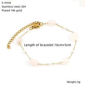 Detailed close-up of 18k gold plated stainless steel bracelet with pink stone and pearls