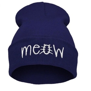 Detailed embroidery of MEOW text with cat face design on a dark blue knit beanie