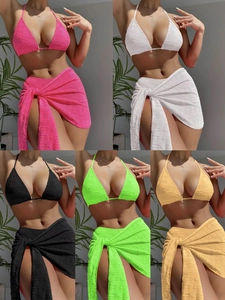 Detail of 3-piece bikini set with textured jacquard fabric and wrap skirt in vibrant colors