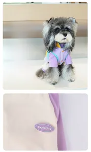 Detail of color-block fleece pet vest showing the textured emblem and D-ring attachment