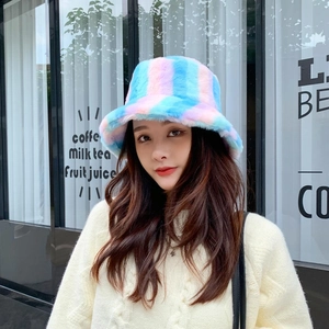 Detail view of pink and blue rainbow fuzzy bucket hat with soft plush texture
