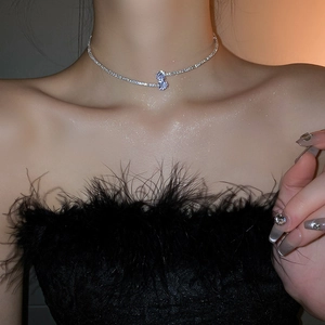 Close-up of double-layer silver choker necklace with teardrop pendant worn by model