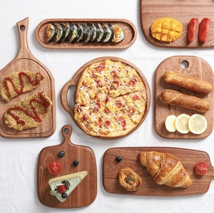 Mini ebony wood cutting boards in various shapes with food for baby serving