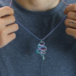 Close-up of rainbow stainless steel snake pendant with matching box chain on model