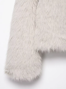 Close-up of fluffy faux fox fur texture on light gray jacket showing high density fibers