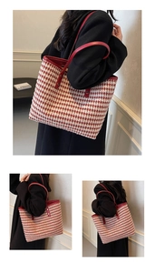 Detailed view of red houndstooth tote bag with PU leather handles and premium trim