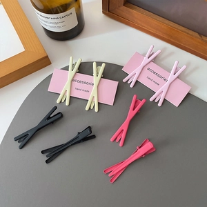 Candy colored crossover hair clips for women in yellow, pink and black matte finish