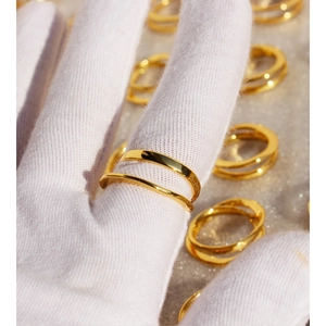 Minimalist double layered irregular line cross ring in golden finish on hand