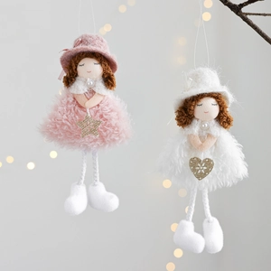 Detail of pink and white plush angel ornaments with gold sequins hanging on branches