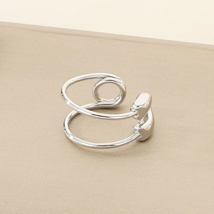 Macro shot of silver-colored double-layer spiral open ring with polished metal finish
