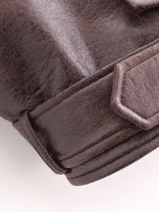 Detailed macro view of dark brown PU leather texture and premium stitching craftsmanship