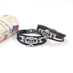 Punk leather bracelets with skull charms and beads in black and brown layers