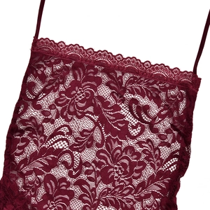 Macro shot of dark red floral lace texture and intricate neck edging on the dress
