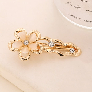 Detailed macro view of Y2K gold flower hair clip with opal petals and crystal accents