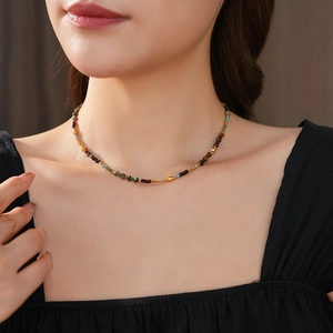 Close-up of bohemian colorful stone beaded necklace worn by a professional model