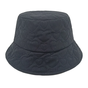 Detailed view of black corduroy bucket hat featuring quilted heart pattern texture