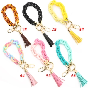 Assorted acrylic link keychain bracelets with stylish tassels and gold metal clasps