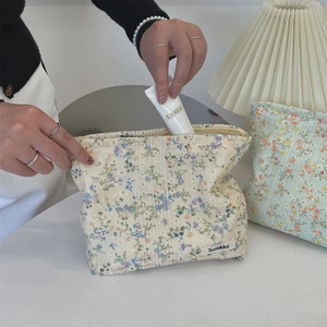 Floral canvas makeup bag detail showing large capacity storage with a skincare jar