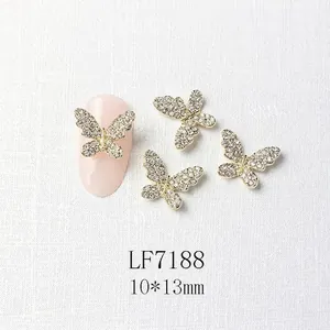 Detailed view of 10x13mm gold butterfly nail art charms with micro-pave crystals
