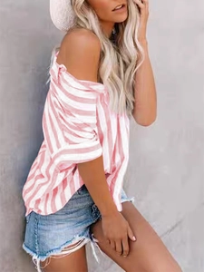 Woman wearing pink and white striped off-shoulder casual shirt with denim shorts