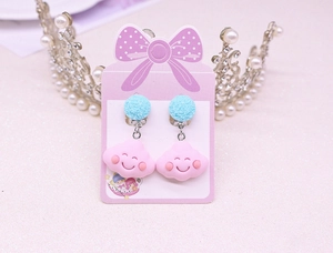 Detail showing pink cloud clip-on earrings for kids with cute smile and blue glitter charms