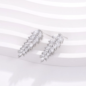 Close-up of geometric silver earrings featuring marquise-cut cubic zirconia stones