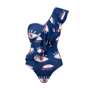 Detail of ruffle trim and evil eye print on a navy blue one-shoulder swimsuit for women