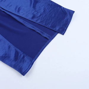 Detailed close-up of the side slit and fine stitching on a royal blue satin dress