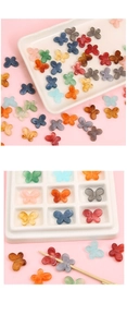 Macro shot of colorful gradient acrylic butterfly beads for DIY jewelry making and crafts