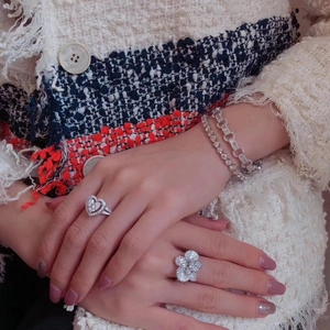 Elegant jewelry set including heart ring and gemstone bracelets worn on model