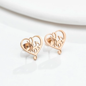 Elegant rose gold heart earrings featuring musical note designs on a white surface