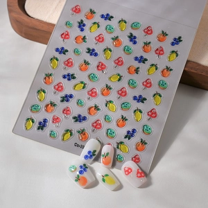Close-up of 5D fruit nail stickers with embossed textures of strawberry and lemon