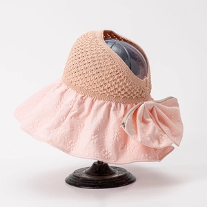 Detail of sun visor with floral relief texture and large pink bow decoration