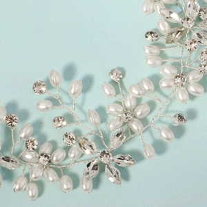 Handmade bridal hair comb with silver wire, white pearls and sparkling crystals on blue