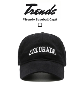 Detailed close-up of white 3D COLORADO embroidery on a black cotton baseball cap