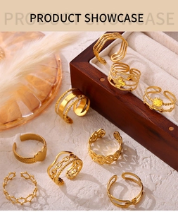 Detailed view of gold plated open rings set featuring heart and sun motifs on jewelry stand