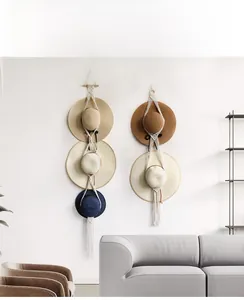 Detail of bohemian wall-mounted cotton rope hat organizer with elegant fringe tassels