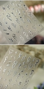 Close-up of Y2K silver metal nail stickers with 3D heart and cross star patterns