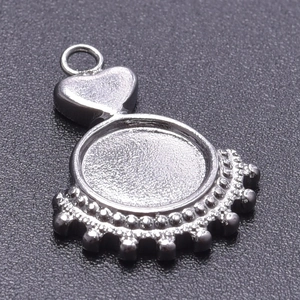 Close-up of silver heart-shaped stainless steel pendant tray with beaded edge for DIY jewelry