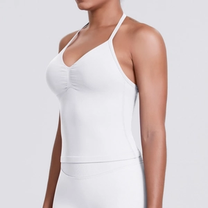 Detailed close-up of the white V-neck seamless yoga top with gathered ruching details