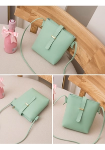 Detail of mint green crossbody bag with gold buckle and knotted shoulder strap