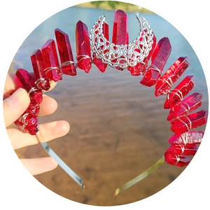Red natural crystal moon crown headband with silver crescents over a water and sand backdrop
