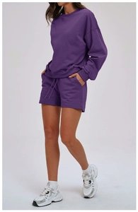 Detail view of purple loungewear set with crewneck sweatshirt and drawstring shorts