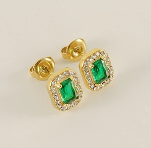 Macro detail of rectangle emerald zircon earrings with gold plating and butterfly backs