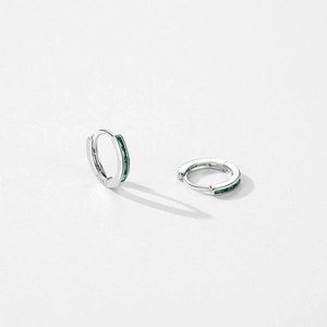 S925 sterling silver hoop earrings with green zircon stones in a studio setting