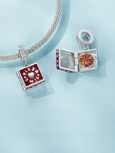 Macro detail of S925 silver pizza charm with red enamel and hinged opening feature