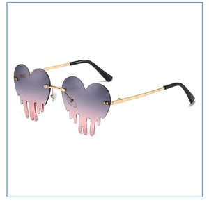 Macro detail of heart shaped drip sunglasses with gold metal frame and gradient lenses